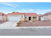 Charming single-story home with a red tile roof and a two-car garage in a suburban neighborhood at 635 Dry Valley Ave, North Las Vegas, NV 89031