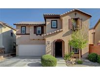 Charming two-story home featuring a neutral color palette, arched entry, and a two-car garage at 10666 Cherry Ridge Ct, Las Vegas, NV 89129