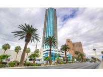 Striking exterior view of a modern high-rise building with palm trees and city views in the background at 2700 Las Vegas Blvd # 3501, Las Vegas, NV 89109