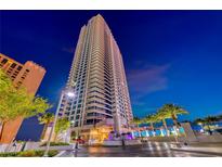 High-rise condo building with fountain and landscaping at night in Las Vegas at 2700 Las Vegas Blvd # 3501, Las Vegas, NV 89109