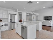 Modern kitchen features stainless steel appliances, white cabinetry and countertops, and a spacious island at 4525 Dean Martin Dr # 3006, Las Vegas, NV 89103