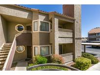 Attractive condo featuring a private balcony, beautiful landscaping, and convenient covered parking at 5032 S Rainbow Blvd # 206, Las Vegas, NV 89118