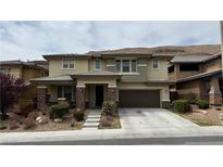 Beautiful two-story home featuring desert landscaping, a large front porch, and a two-car garage at 5615 Oak Bend Dr, Las Vegas, NV 89135