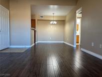 Inviting living room featuring hardwood floors and neutral paint scheme, ready for your personal touch at 6650 W Warm Springs Rd # 2173, Las Vegas, NV 89118