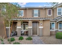 Inviting two-story townhome with cozy front porch and desert landscaping at 7068 Salt Plains St, North Las Vegas, NV 89086