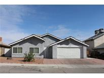 Charming single-story home featuring a well-maintained front yard and attached two-car garage at 7170 Mountain Moss Dr, Las Vegas, NV 89147