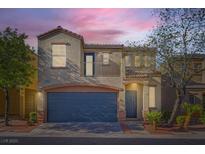 Charming two-story home featuring a blue garage door and a second-story balcony at 9066 Hilverson Ave, Las Vegas, NV 89148