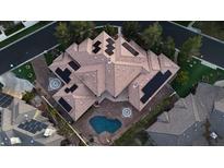 Stunning aerial view of a home featuring solar panels, a backyard pool, and manicured landscaping at 3008 Astoria Pines Cir, Las Vegas, NV 89107
