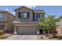 Inviting two-story home with a well-manicured front yard and a two-car garage at 5589 Pico Ferrera Ct, Las Vegas, NV 89113
