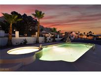 Beautiful pool with hot tub surrounded by palm trees with mountain views at sunset at 6861 E Washington Ave, Las Vegas, NV 89110