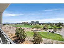 Beautiful golf course view from balcony with golf carts and players on the green under a vast blue sky at 9213 Las Manaitas Ave # 401, Las Vegas, NV 89144