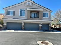 Inviting home featuring a three-car garage and a charming second-story balcony at 6045 Riverwalk Falls St # 102, North Las Vegas, NV 89031