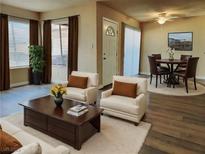 Open living room features wood flooring, neutral paint, and updated furniture at 1450 Hialeah Dr # D, Las Vegas, NV 89119