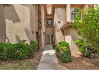 Inviting townhouse entrance with well-manicured landscaping and a desert color palette at 2050 W Warm Springs Rd # 1822, Henderson, NV 89014