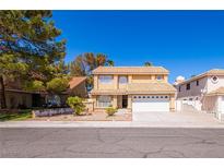 Charming two-story home featuring a well-maintained yard and attached two-car garage with a driveway at 2105 Harbor Cliff Dr, Las Vegas, NV 89128