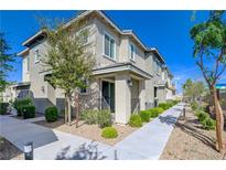 Charming two-story townhome with a well-maintained walkway and inviting curb appeal on a bright, sunny day at 5730 Sky Pointe Dr # 104, Las Vegas, NV 89130