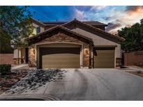 Charming two-story home showcasing a stone accent façade and attached three-car garage at 6489 Crest Estates St, Las Vegas, NV 89131