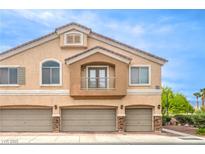 Inviting exterior view of a three-car garage townhome with a small, quaint balcony at 6617 Lavender Lilly Ln # 1, North Las Vegas, NV 89084
