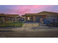 Charming single-story home featuring a gated front yard and covered parking at 7047 Mountain Meadow Ln, Las Vegas, NV 89147