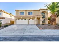 Two-story home featuring a desert landscape, three-car garage and well-maintained lawn at 8617 Copper Ridge Ave, Las Vegas, NV 89129