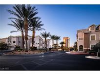A picturesque street view with palm trees lining the road, showcasing the community's well-maintained landscaping at 8777 W Maule Ave # 1087, Las Vegas, NV 89148