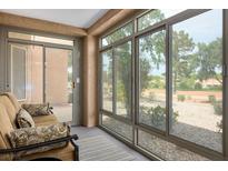 Bright sunroom featuring large windows offering lots of natural light and a comfortable seating area at 9000 Sundial Dr, Las Vegas, NV 89134