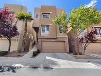 Inviting two-story home with a two-car garage and desert landscaping at 9267 Lapeer St, Las Vegas, NV 89178