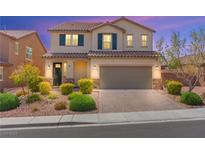 Charming two-story home featuring a well-manicured front yard and a two-car garage at 9277 Ardoa Ave, Las Vegas, NV 89148