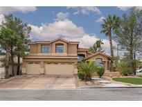 Charming two-story home featuring a three-car garage, desert landscaping, and a beautiful red tile roof at 10325 Falls Church Ave, Las Vegas, NV 89144