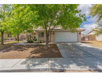 Charming single-story home features a tile roof, desert landscaping, and a two-car garage at 1133 Mount Olympias Ct, Las Vegas, NV 89110