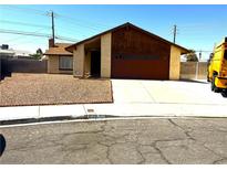 Charming single-story home with a well-maintained front yard and a two-car garage at 1208 Winwood St, Las Vegas, NV 89108