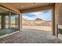 Beautiful brick patio with mountain views in the background provides ample outdoor space at 138 Crimson Cactus Ave, Henderson, NV 89011