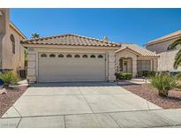 Charming single-story home featuring a tile roof, well-manicured landscaping, and a spacious two-car garage at 1751 Juniper Twig Ave, Las Vegas, NV 89183