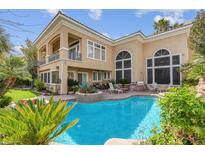 Stunning outdoor pool with lush landscaping and attached spa for ultimate relaxation and enjoyment at 2024 Glenview Dr, Las Vegas, NV 89134