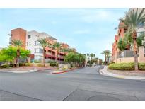 View of the beautiful condo community with landscaping and manicured grounds and attractive building exteriors at 23 E Agate Ave # 207, Las Vegas, NV 89123