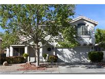 Charming two-story home features a well-manicured front yard and a two-car garage, inviting curb appeal at 2305 Flower Spring St, Las Vegas, NV 89134