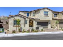 Charming two-story home boasting a well-manicured front yard, tile roof, and an attached two-car garage at 253 Malpaso St, Las Vegas, NV 89138