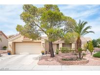 Charming single-story home boasts a desert landscape, mature trees and an attached two car garage at 2737 Tumble Brook Dr, Las Vegas, NV 89134
