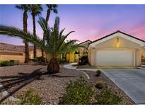 Charming single Gathering home with a two car garage, desert landscaping and swaying palm trees at 3016 High Range Dr, Las Vegas, NV 89134