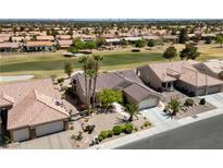 Beautiful single-story home with well-maintained landscaping and tile roof, surrounded by lush green golf course at 3016 High Range Dr, Las Vegas, NV 89134