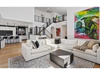 Bright, open living room with modern decor and staircase leading to the second floor at 3038 Villanelle Ave, Henderson, NV 89044