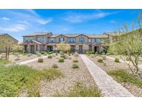 Inviting townhome with desert landscaping, providing a serene and low-maintenance outdoor space at 3295 Pergusa Dr, Henderson, NV 89044