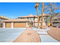 Charming home featuring a three-car garage and a landscaped yard with mature trees and a stone walkway at 3382 Montessouri, Las Vegas, NV 89117
