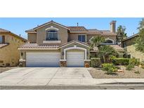 Charming two-story home featuring a three-car garage, arched windows and well-maintained landscaping at 3749 Climbing Rose St, Las Vegas, NV 89147