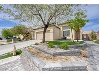 Charming single-story home with a well-maintained yard, desert landscaping, and mature trees at 3760 Candytuft Ridge Ave, North Las Vegas, NV 89081