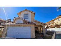 Inviting two-story home features a neutral color palette, garage, and tiled roof at 3871 Sir Bret Ct, Las Vegas, NV 89104