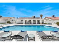 Beautiful backyard pool with lounge chairs under a bright blue sky offers an inviting outdoor retreat at 4452 Paseo El Rio Dr, Las Vegas, NV 89121