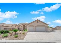 Inviting single-story home featuring a manicured yard and a spacious two-car garage and driveway at 6781 Alpine Brooks Ave, Las Vegas, NV 89130