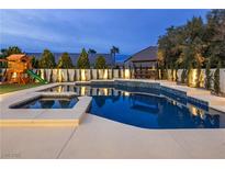 Beautiful backyard pool with a playset, manicured landscaping, and relaxing swing at 8000 Clock Tower Ct Ct, Las Vegas, NV 89117