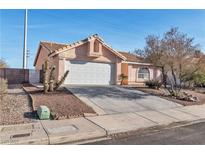 Charming single-story home with a two-car garage, desert landscaping, and a warm, inviting curb appeal at 918 Ambusher St, Henderson, NV 89014